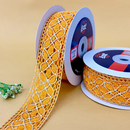 Two spools of orange lace ribbon with a decorative pattern on a beige background.