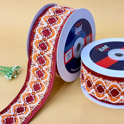 Two spools of decorative ribbon with a red and white pattern on a beige background.