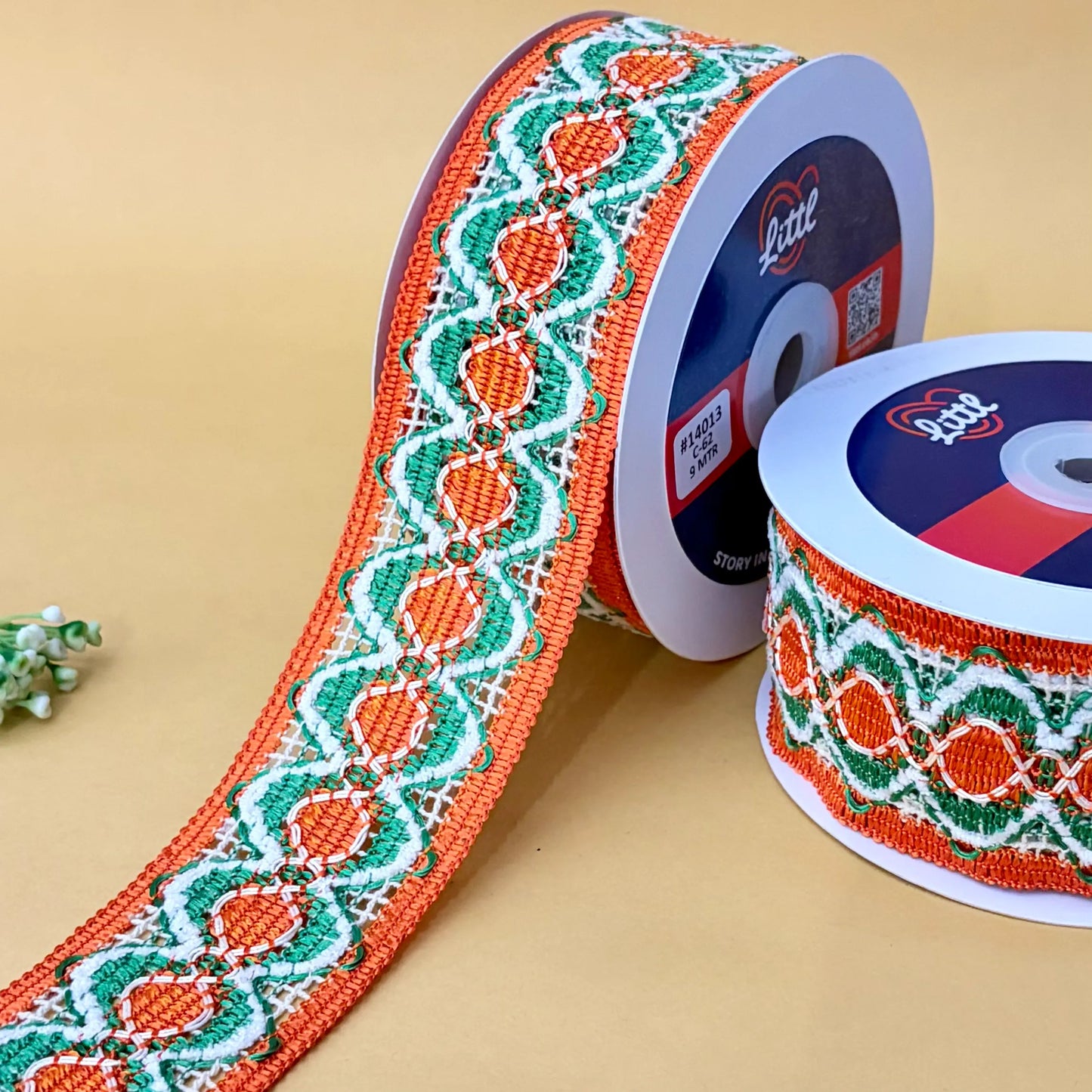 decorative ribbon with orange and green pattern on a beige background