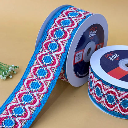 Two spools of patterned ribbon with 'Little' branding on a beige background