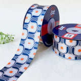 Daisy Tile Retro printed satin ribbon roll, white daisies with orange centres in navy tiles on grey with a white back, 1.5 inch (38 mm) – Littl