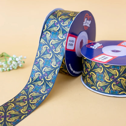 Two spools of decorative ribbon with a floral pattern on a beige background