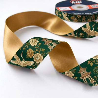 Close-up of Crane Pavilion ribbon: golden cranes, peonies and a pagoda printed on forest green satin