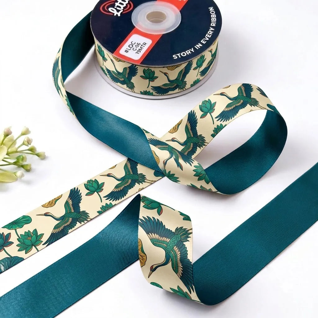 Crane & Lotus ribbon twisted to show the printed front and solid deep teal back