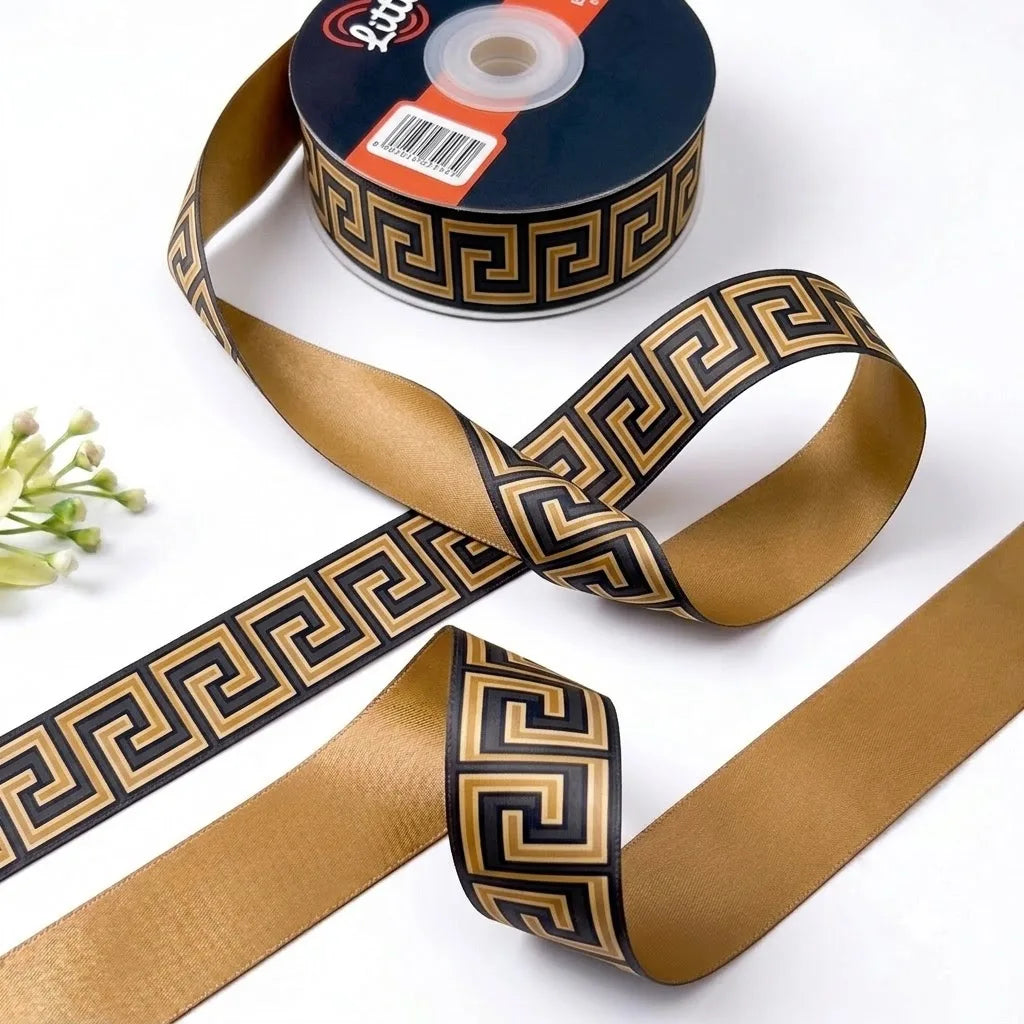 Greek Key ribbon twisted to show the printed front and solid antique gold back