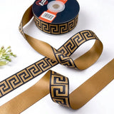 Greek Key ribbon twisted to show the printed front and solid antique gold back