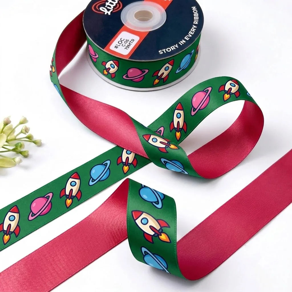 Rocket Ride ribbon twisted to show the printed front and solid cherry red back