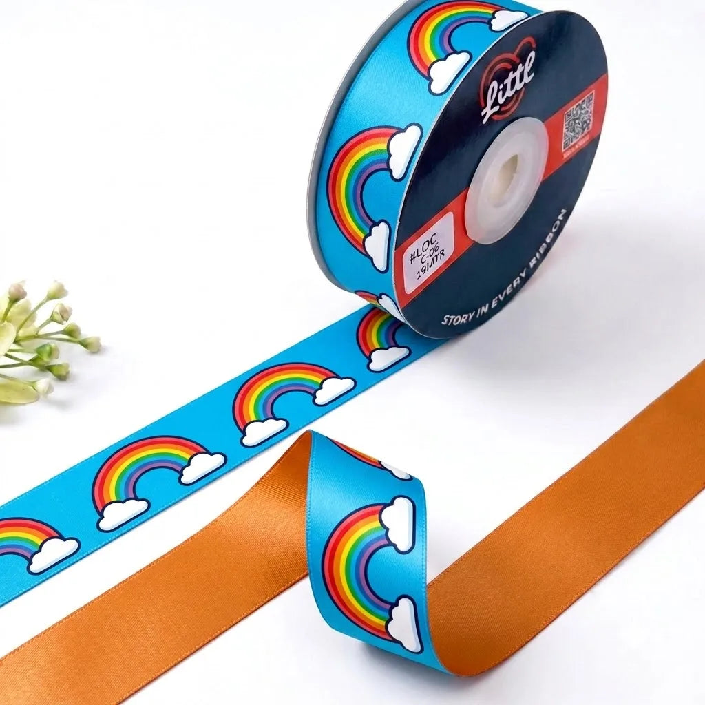 Rainbow Clouds Kids printed satin ribbon roll, rainbows and white clouds on sky blue with a solid tangerine orange back, 1 inch (25 mm) – Littl