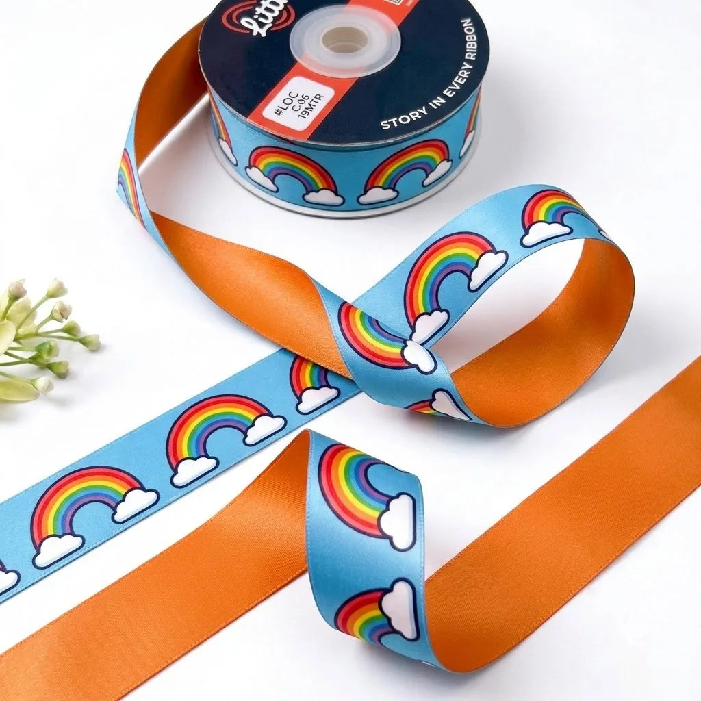 Rainbow Clouds ribbon twisted to show the printed front and solid tangerine orange back