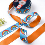 Rainbow Clouds ribbon twisted to show the printed front and solid tangerine orange back