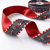 Close-up of Race Day ribbon: race cars and chequered flags printed on charcoal grey satin