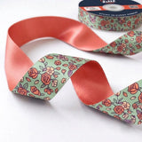 Close-up of Rose Ditsy ribbon: small pink roses printed on mint green satin
