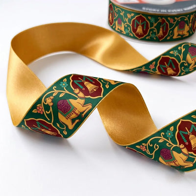 Close-up of Camel Darbar ribbon: royal camels and jharokha arch medallions printed on bottle green satin