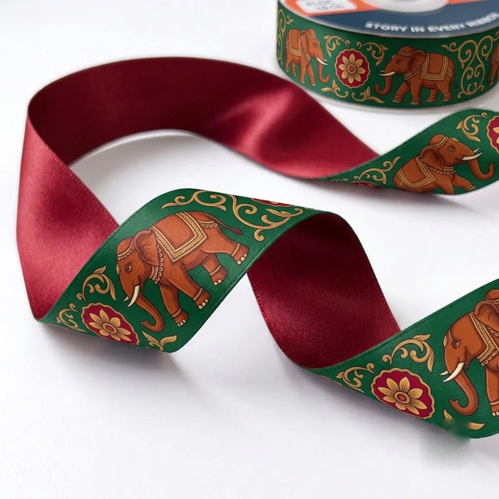 Close-up of Elephant Mela ribbon: red elephants and florals printed on emerald green satin
