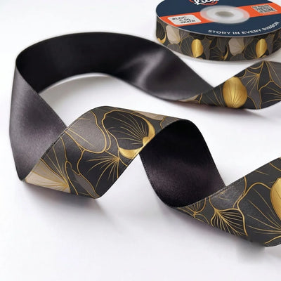 Close-up of Ginkgo Noir ribbon: gold-lined ginkgo leaves printed on charcoal satin