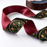 Close-up of Paisley Jaal ribbon: gold and green paisley jaal printed on black satin