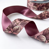 Close-up of Mauve Leaf ribbon: sketched mauve leaves printed on dusty pink satin