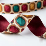 Close-up of Jewel Toran ribbon: ruby, emerald and topaz jewels printed on cream satin