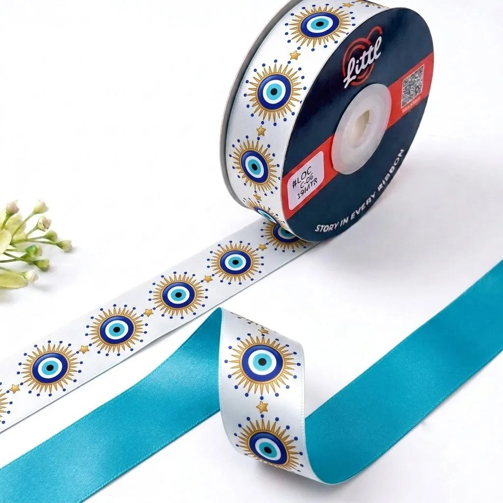 Nazar Sun Evil Eye printed satin ribbon roll, blue evil eyes with gold sunburst rays on white with a solid turquoise back, 1 inch (25 mm) – Littl