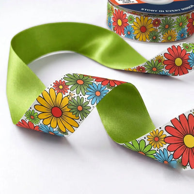 Close-up of Flower Power ribbon: bright daisies in red, yellow, orange and blue printed on white satin, lime green back